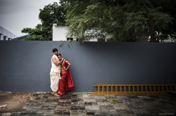 The newlyweds in traditional attires pose for wedding photographers.